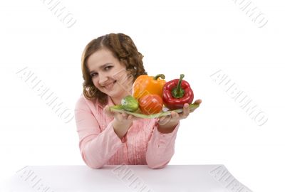 Housewife holding pepper, tomato, cucumber