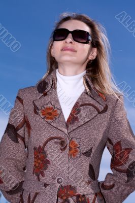 Pretty woman on background blue sky