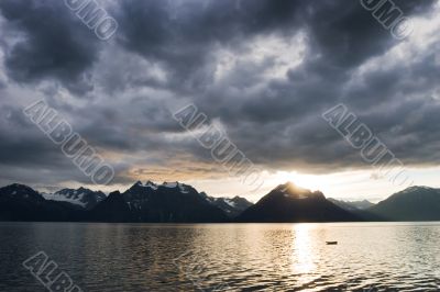 sunset at lake with dark clouds