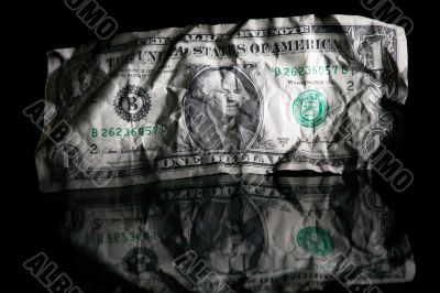 Crumpled dollar isolated on black