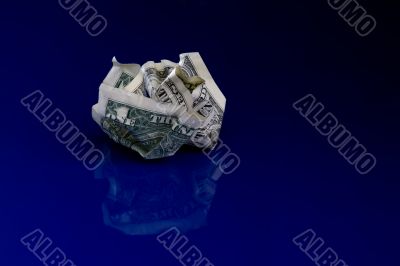 Crumpled dollar isolated on blue