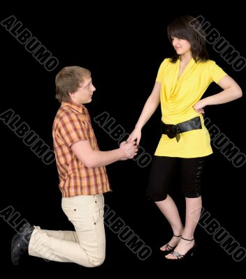 Man is kneeling to the young woman