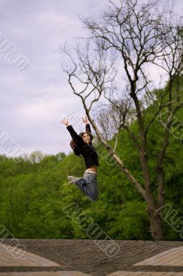young girl jumping in park