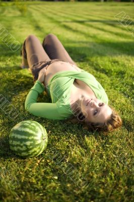 pregnantt woman on grass with melon
