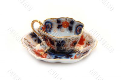 Old teacup with a saucer
