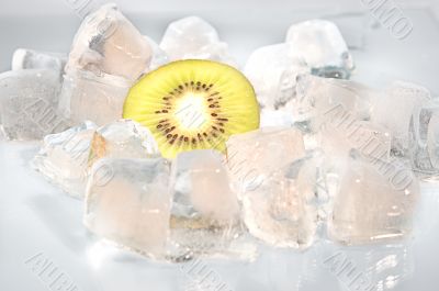 Kiwi with ice on a blue background