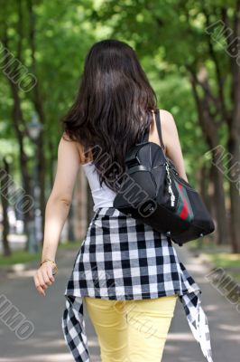 Young Asian woman walking, photo from the rear.