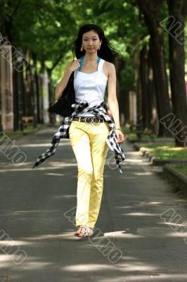 Young Asian woman walking.