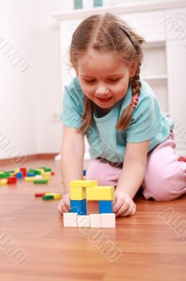 Adorable girl playing with blocks