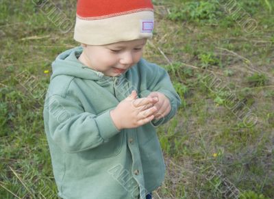 Smal boy is playing with his finger