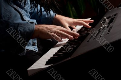 Male Pianist Performs on the Piano Keyboard
