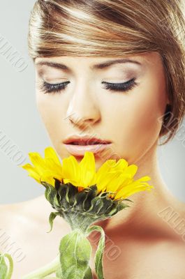 Beautiful woman with a sunflower