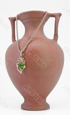 Clay jug and golden necklace