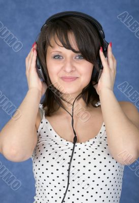 Girl in ear-phones on a blue background
