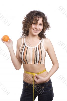 Smiling fit woman with measure tape and orange.