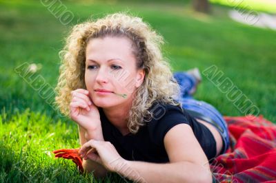 woman lying on green grass