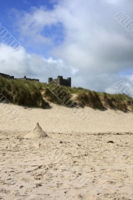Castle partially hidden by the sand dunes.