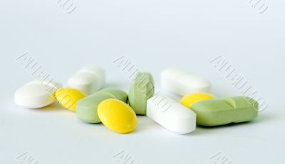 Yellow, green and white pills
