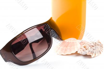 sunglasses, shells and lotion