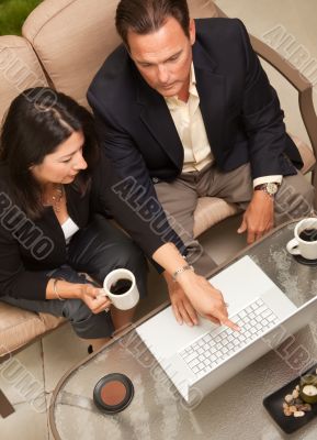 Man and Woman Using Laptop with Coffee