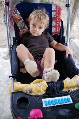 The thoughtful little girl in a carriage