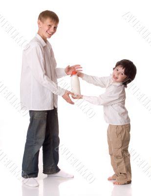 Two brothers with a bottle of milk