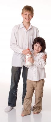 Two brothers with a bottle of milk