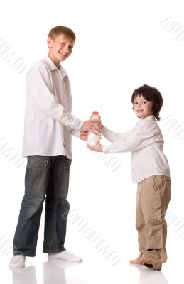 Two brothers with a bottle of milk