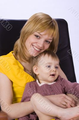 Mother and daughter sitting in a chair