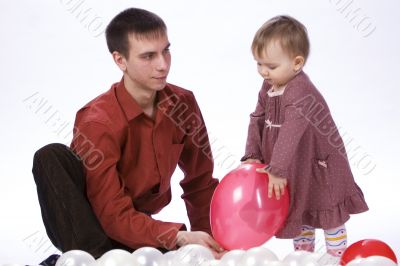 Father and daughter playing balloons