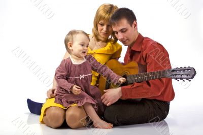 little girl plays the guitar