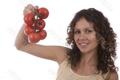 Pretty woman holding branch of red tomatoes