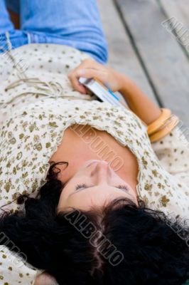woman lying with book