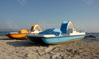 two pedalos on a beach
