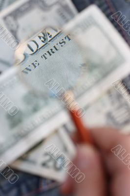 100 USD  banknote is under  a magnifying glass