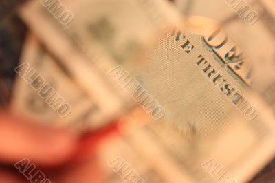 100 USD  banknote is under  a magnifying glass