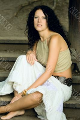 attractive woman sitting on wooden stairs
