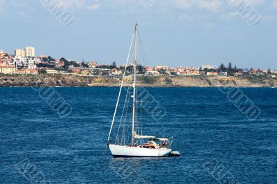 The large, beautiful yacht in the light-blue sea.