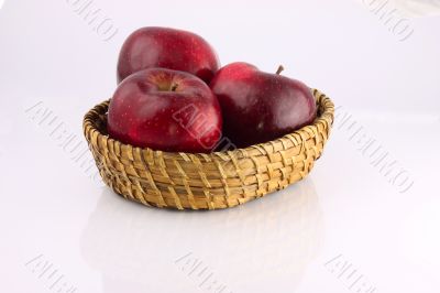 Red apples in a wicker plate