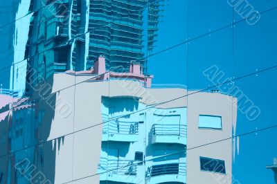 Reflection of a building in glass wall of an office building