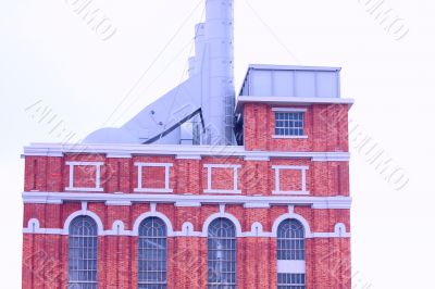 Building of antique factory with chimney