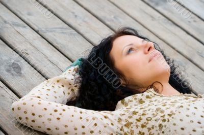 woman lying on wooden floor