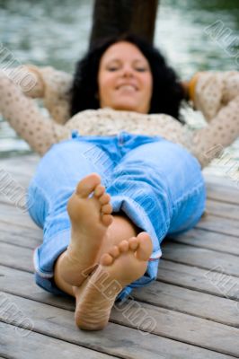 woman lying near the river