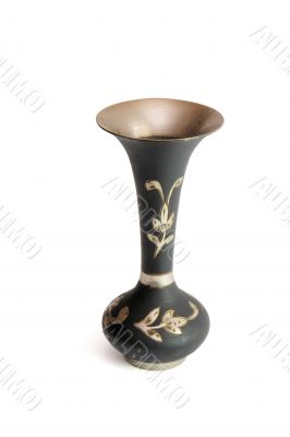 Black metal jug with engraved flowers isolated