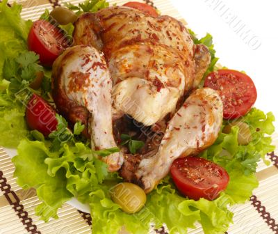 grilled chicken whole with vegetables on salad leafs