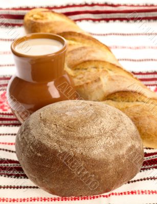 Delicious bread on traditional peasant textile background