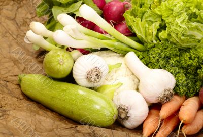fresh tasty vegetables on brown background