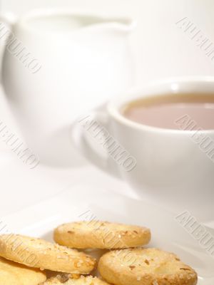 tea cup with cookies on the plate