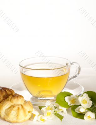 breakfast still-life. green tea with cookies and fresh jasmine