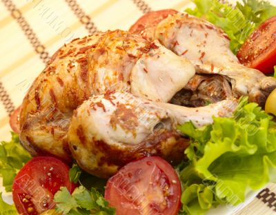 grilled chicken whole with vegetables on salad leafs